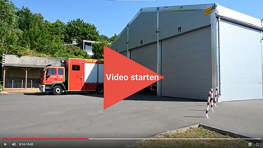 Feuerwehrauto fährt aus Fahrzeughalle
